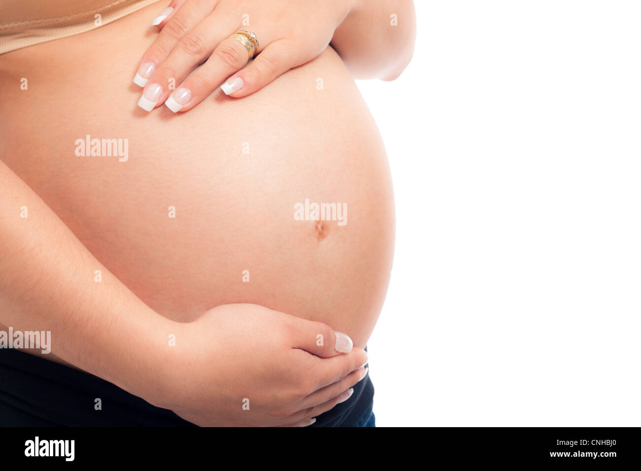 Close up of pregnant woman belly, isolated on white background with copy space. Stock Photo