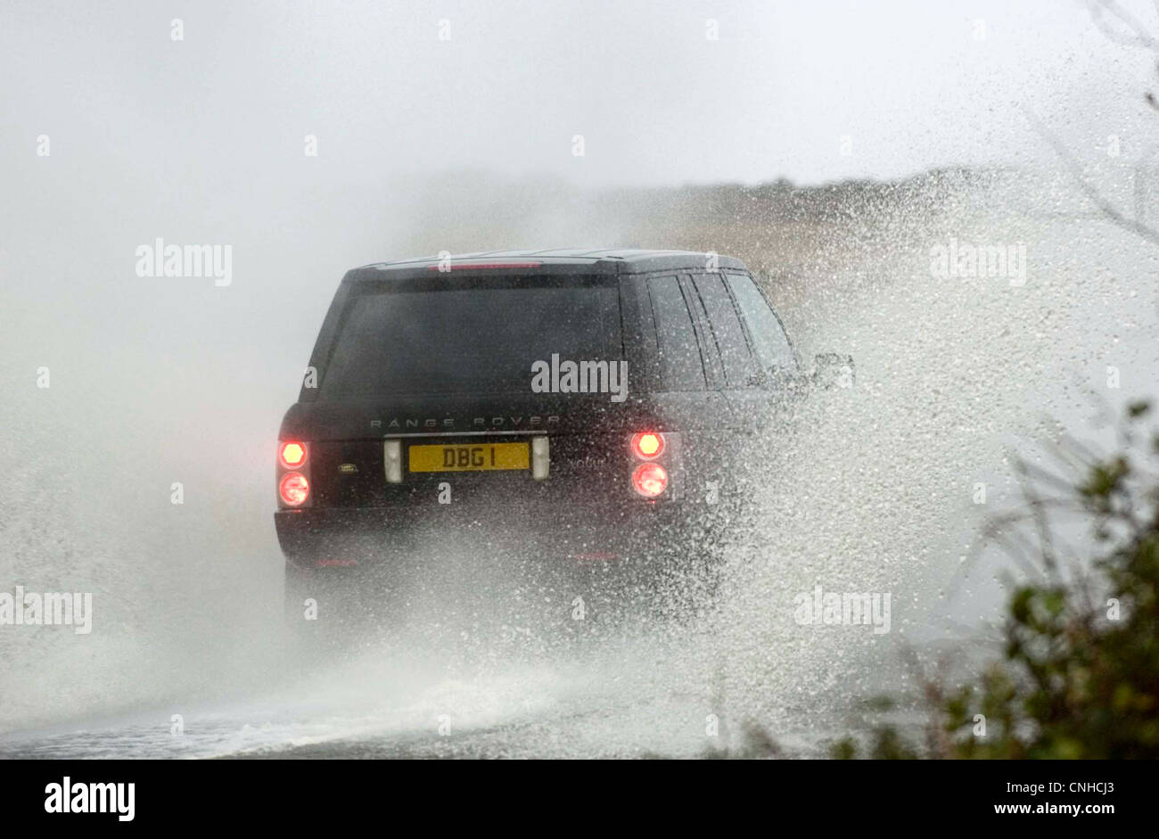 Motorists making their way through the flooded roads of Swansea in South Wales, UK after heavy rain. Stock Photo