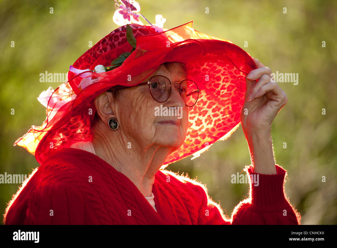 Senior citizen woman wearing red Easter bonnet hat-Victoria, British  Columbia, Canada Stock Photo - Alamy