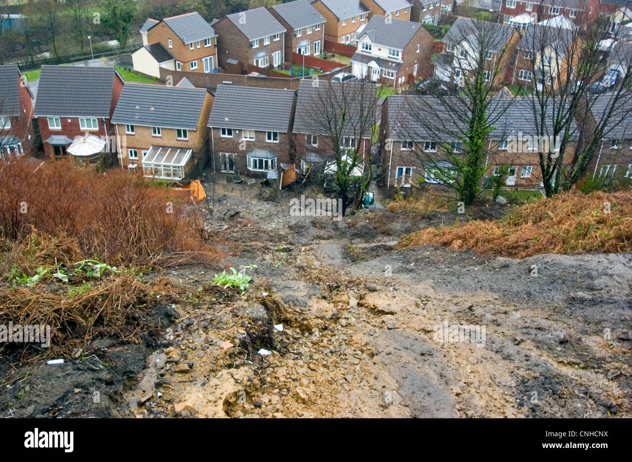 The mudslide in the Taibach area of Port Talbot today after heavy rainfall caused the bank to slip into back gardens. Stock Photo