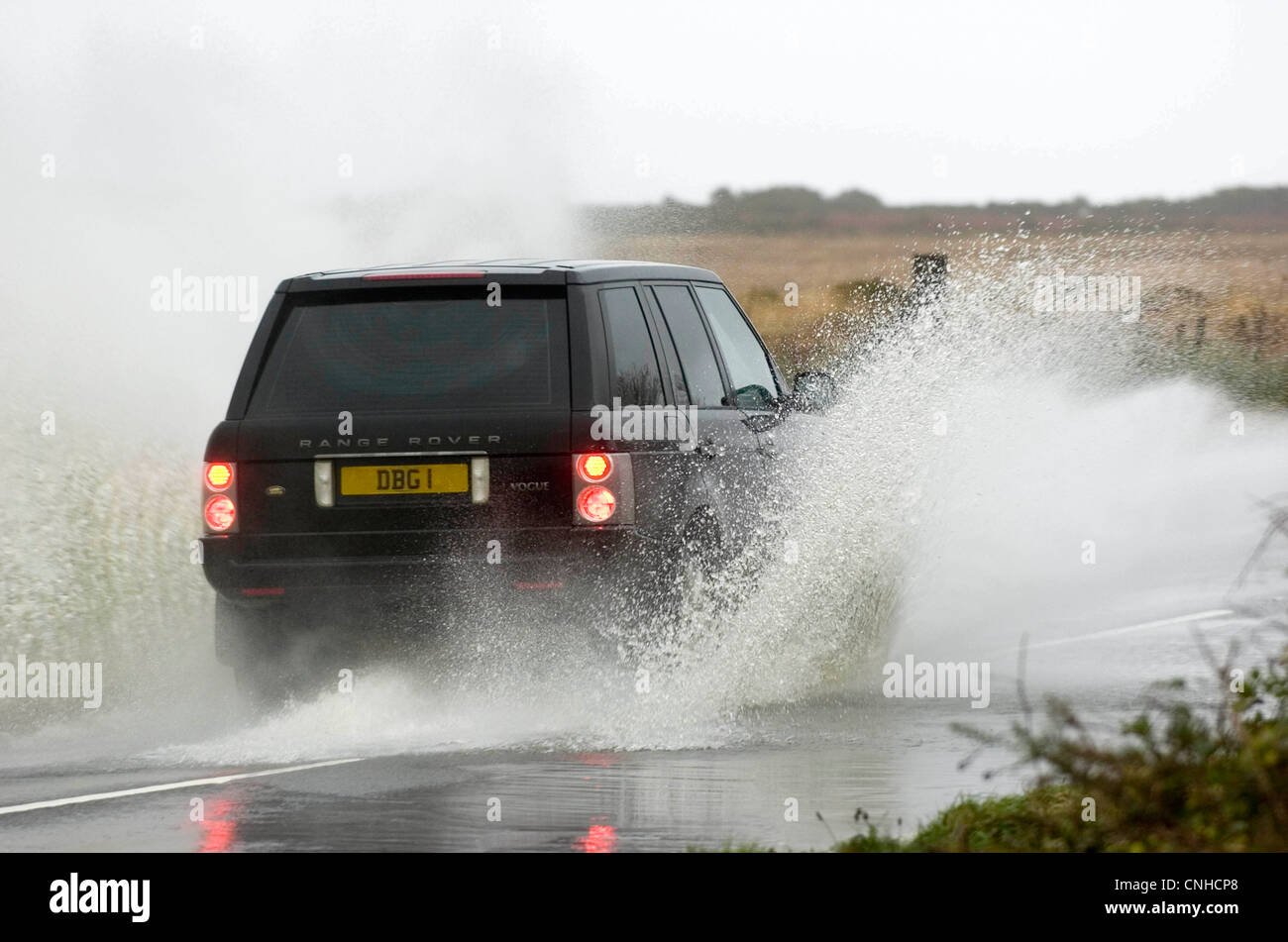 Motorists making their way through the flooded roads of Swansea in South Wales, UK after heavy rain. Stock Photo