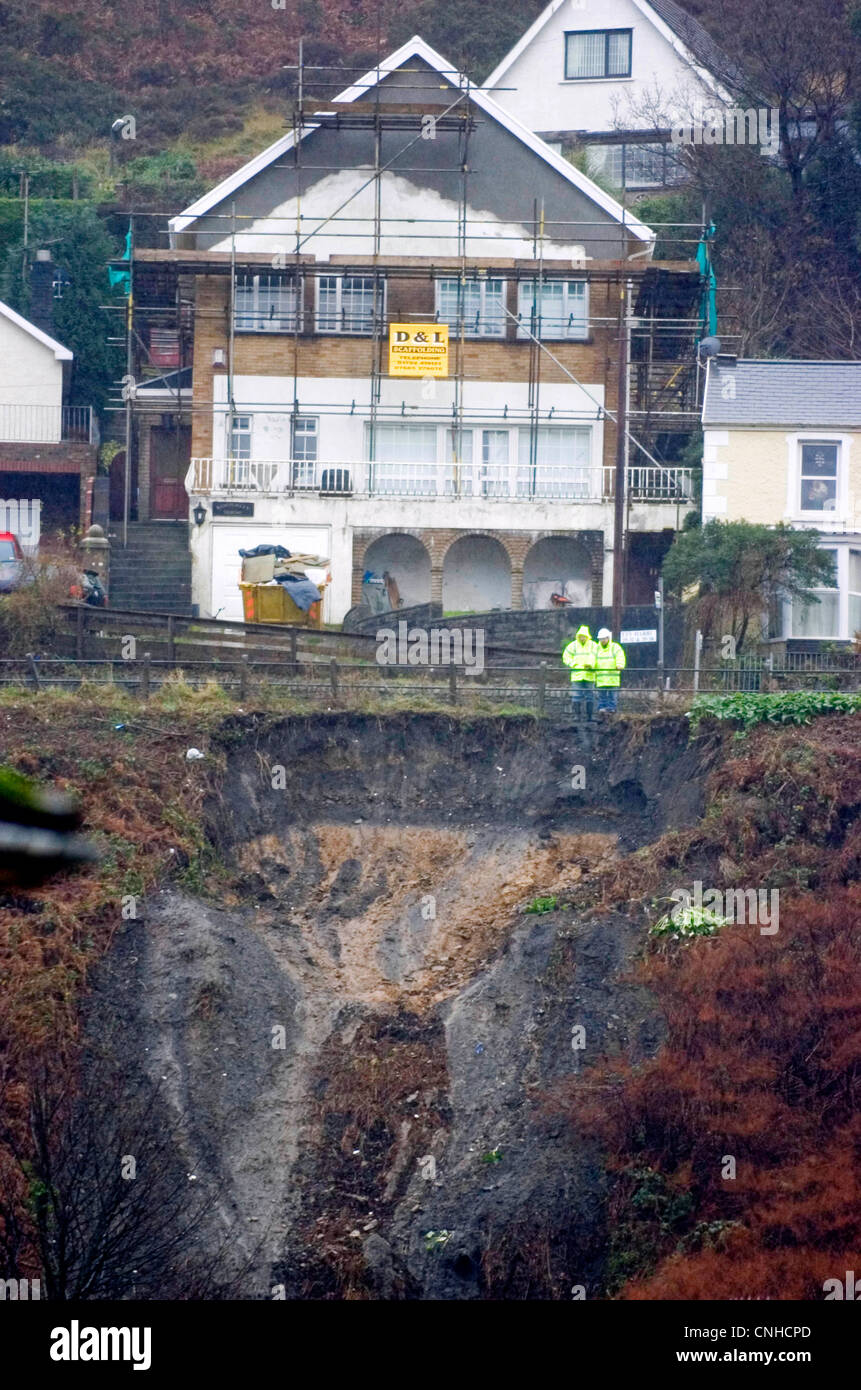 The mudslide in the Taibach area of Port Talbot today after heavy rainfall caused the bank to slip into back gardens. Stock Photo