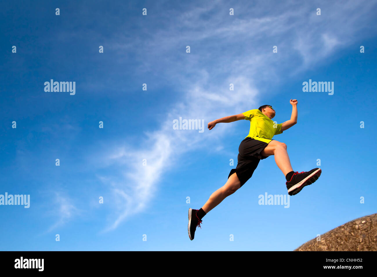 young runner with cloud background Stock Photo
