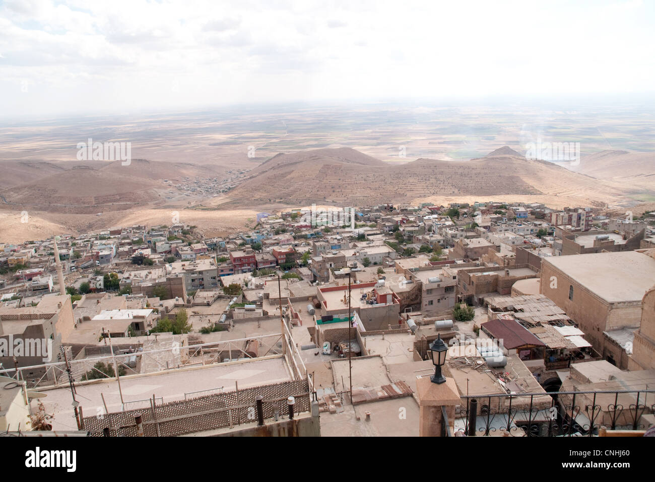 Looking south over rooftops to the Syrian plain from the city of Mardin, in the eastern Anatolia region, southeastern Turkey . Stock Photo