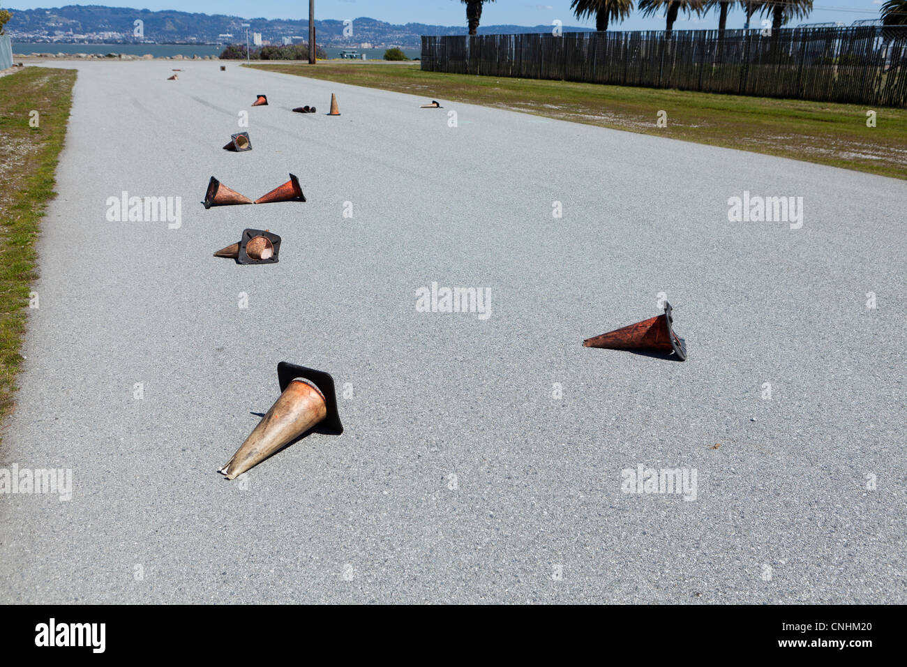 Traffic cones strewn on road Stock Photo