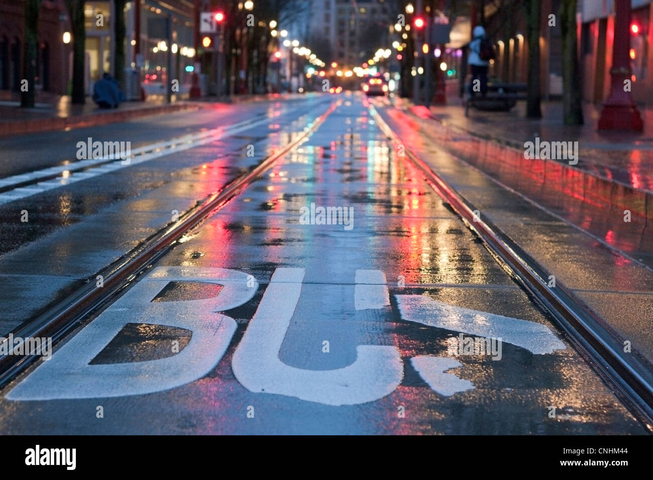 Downtown Portland, Oregon bus lane during a dreary night. Stock Photo