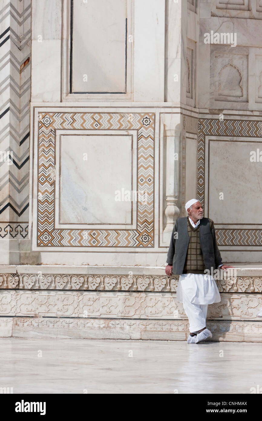 Agra, India. Taj Mahal. Indian Man Wearing Shoe Covers to Protect Taj Tiles from Scratching. Stock Photo