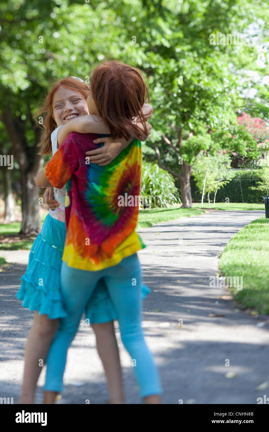 Siblings hugging in Park Stock Photo - Alamy