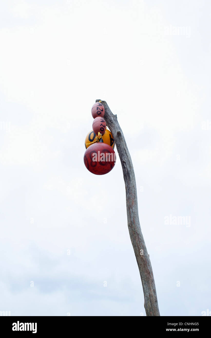 Low angle view of buoys hanging from a wooden post Stock Photo