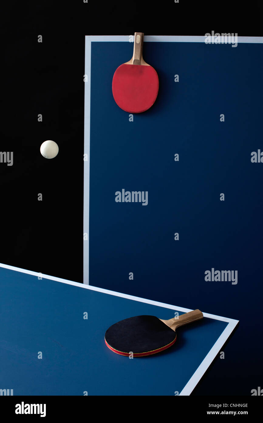 Table tennis tables, bats and a ball midair Stock Photo Alamy