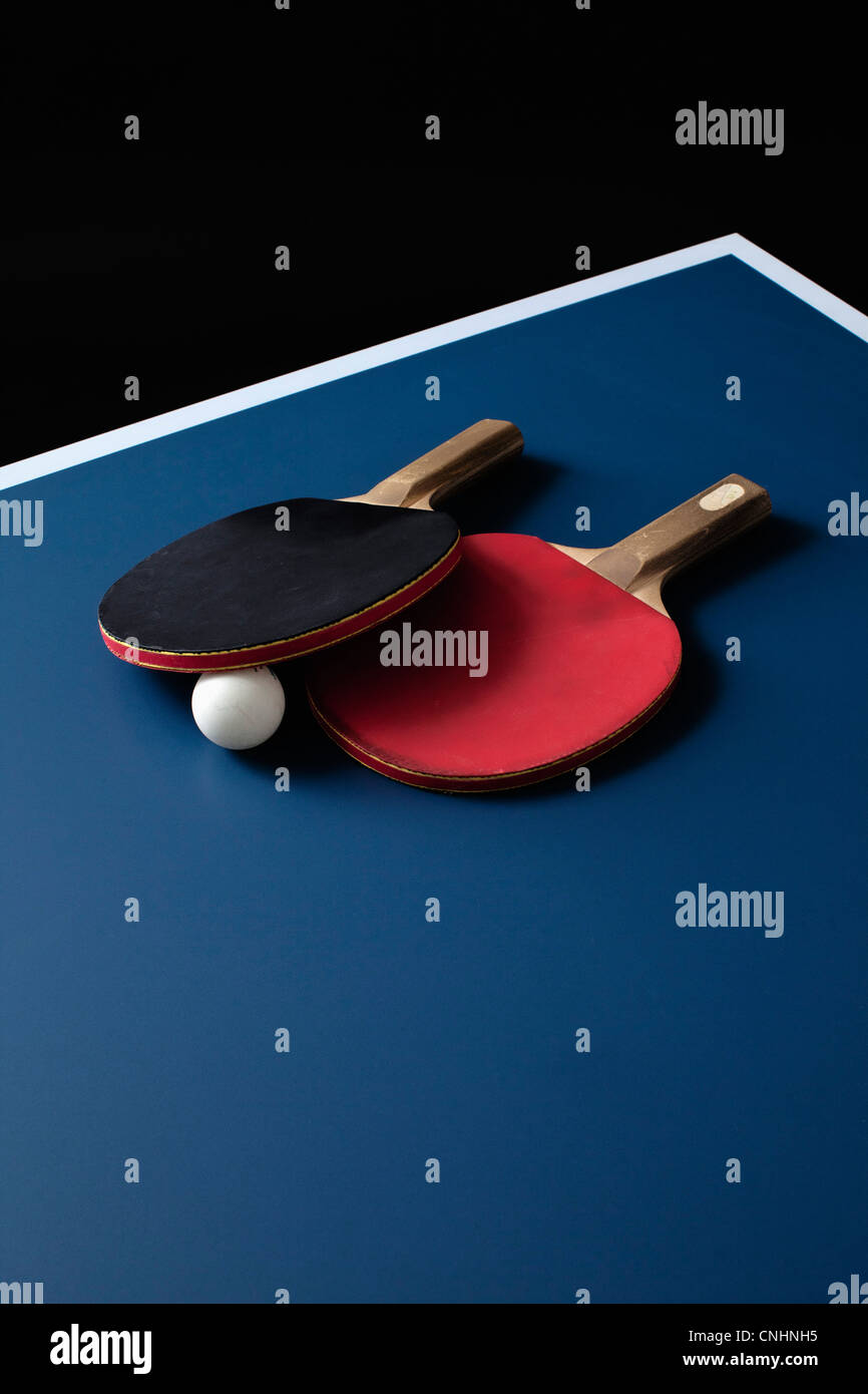 Table tennis bats and a ball on a table Stock Photo Alamy