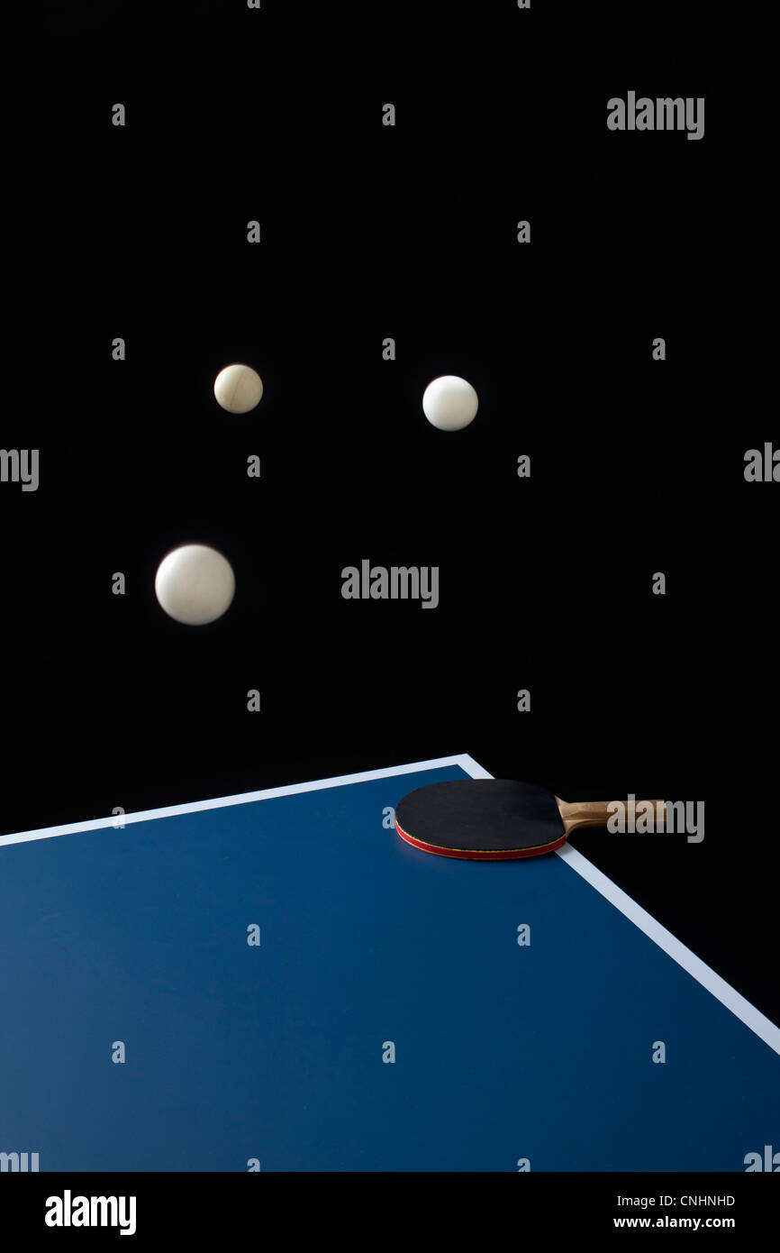 Table tennis balls midair and a bat on a table Stock Photo Alamy