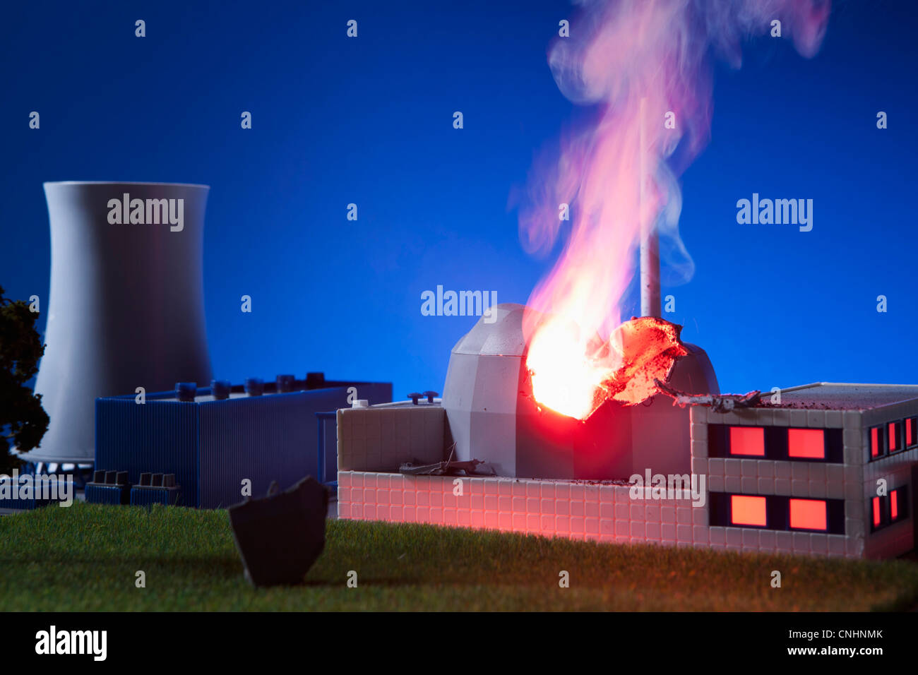 A model built to scale of a nuclear power plant on fire Stock Photo