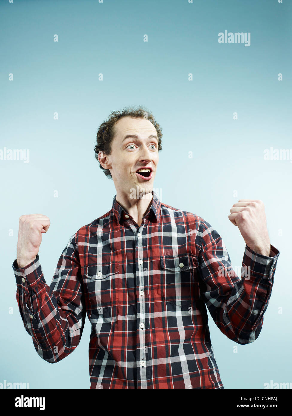 A man with his fists clenched in celebration Stock Photo