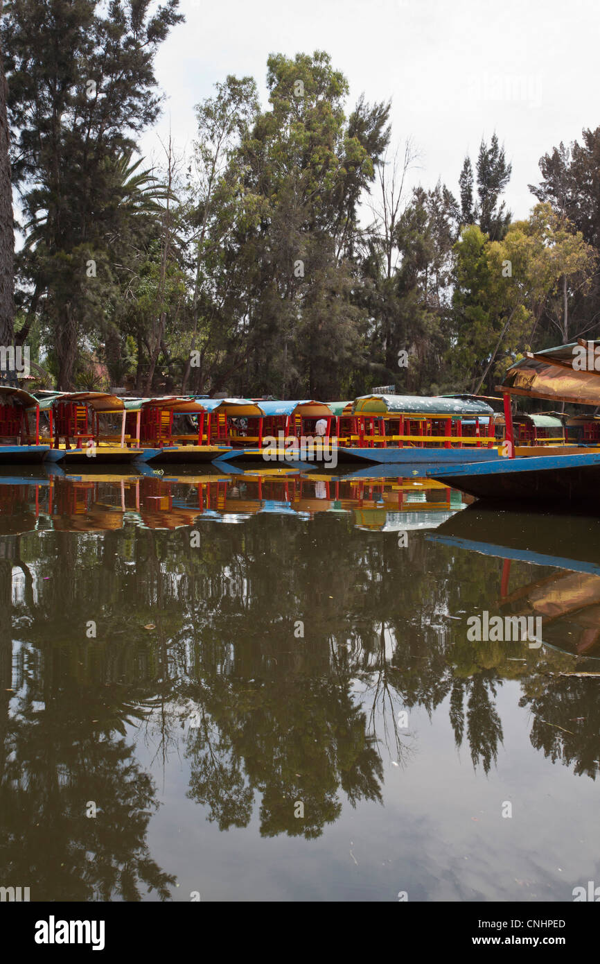 A row of moored Trajineras, a traditional gondola type Mexican tour boat Stock Photo