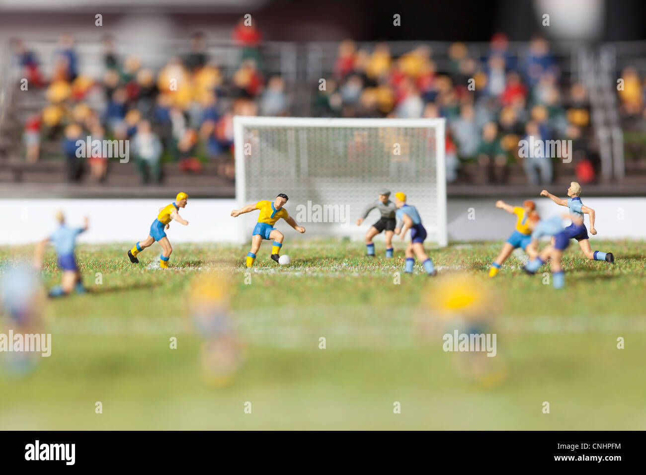 Miniature figurines of two soccer teams playing a soccer match Stock Photo
