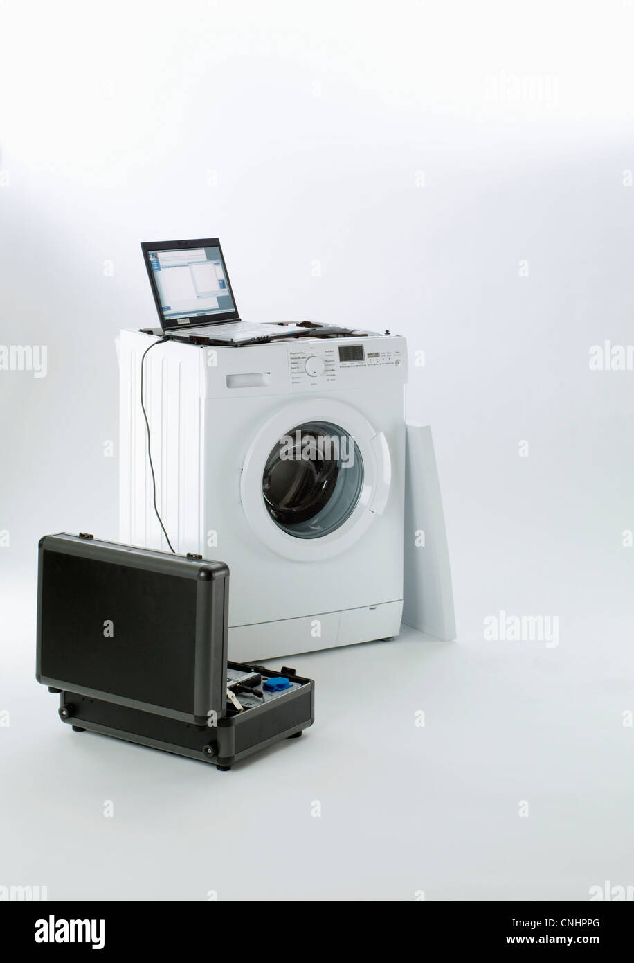 A washing machine being serviced Stock Photo
