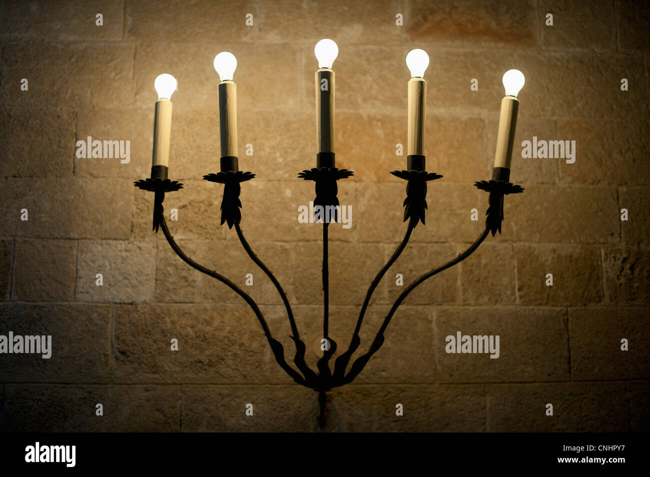 A sconce with illuminated electric candles Stock Photo Alamy