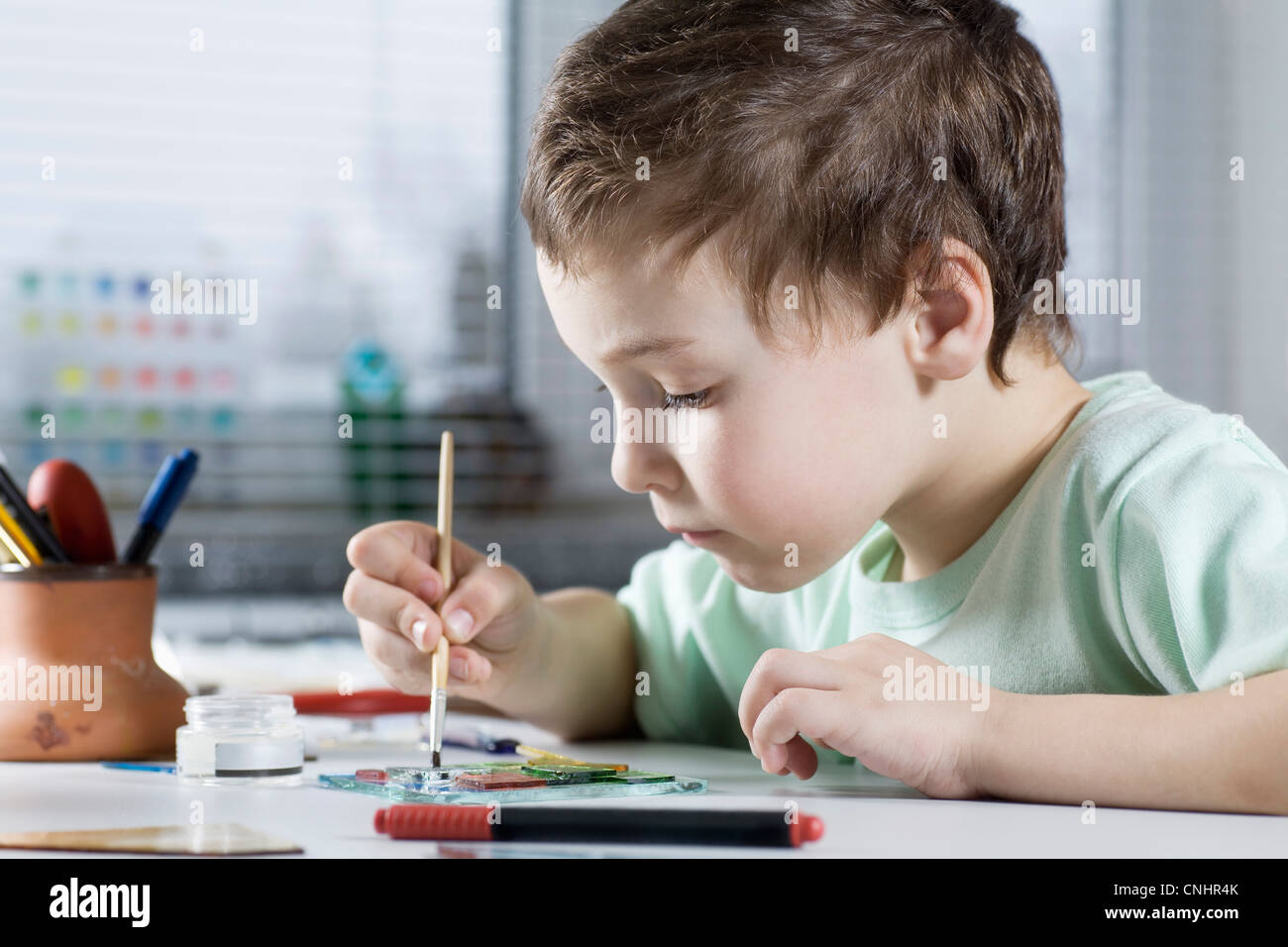 Boy Painting in workshop Stock Photo