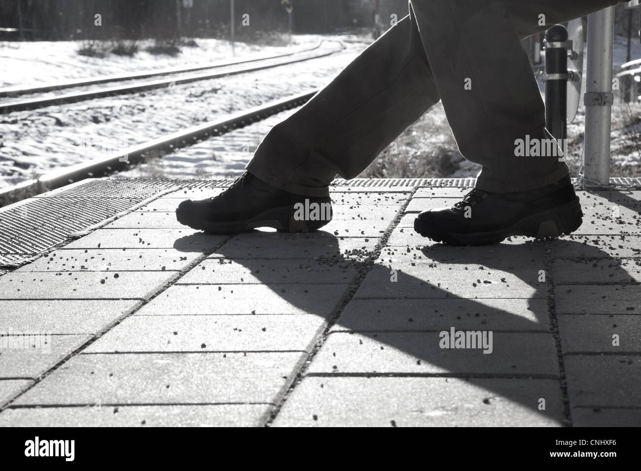 Black and White silhouette images of a seated person waiting at a train ...