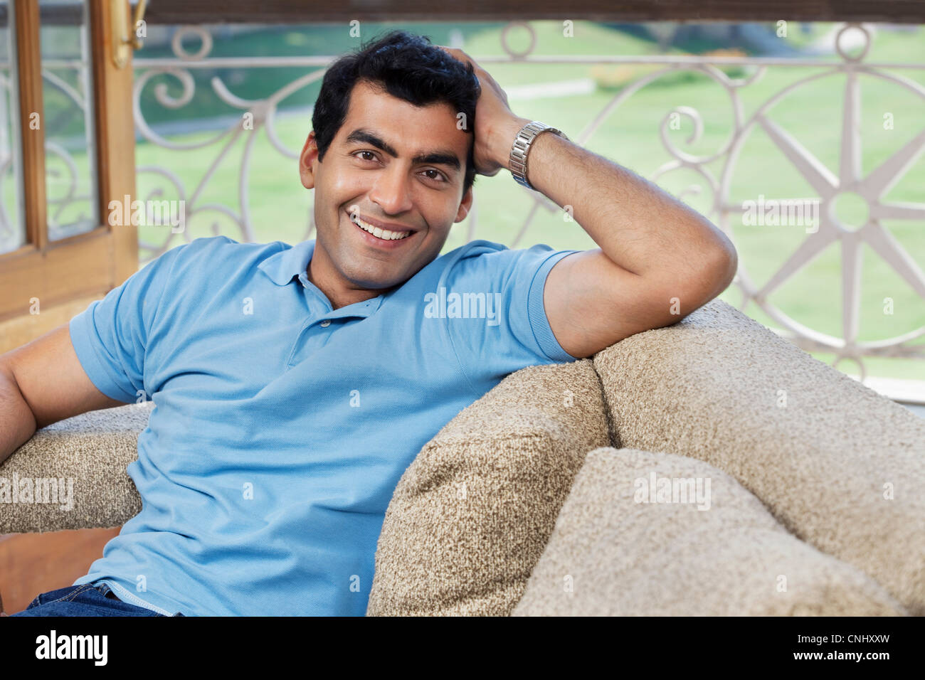 Portrait of a man sitting on a sofa Stock Photo
