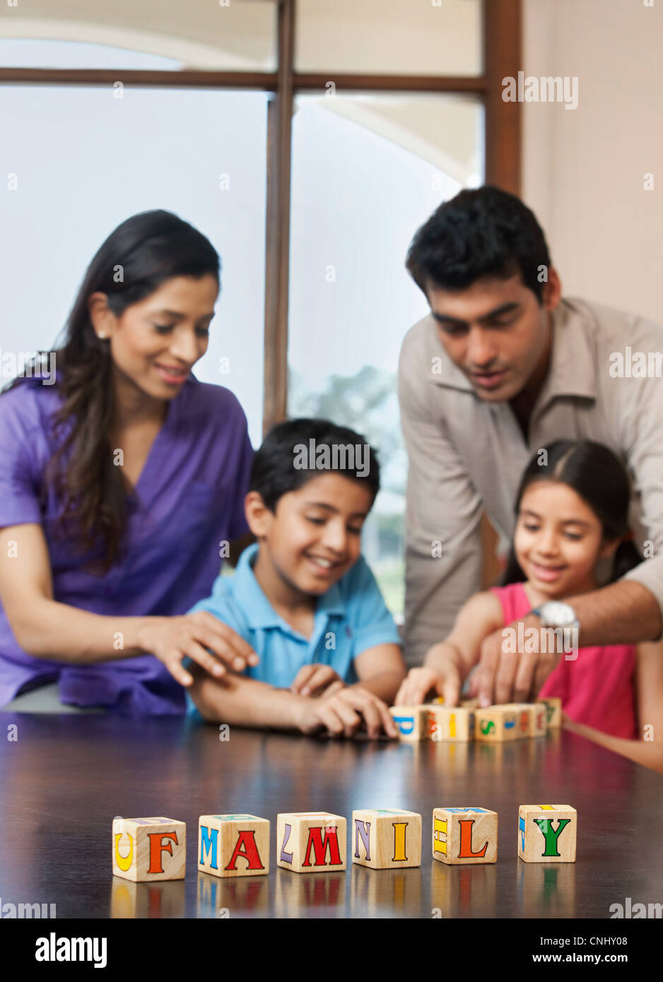 Family playing with building blocks Stock Photo