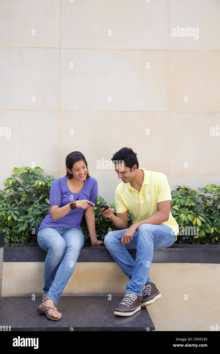 Couple looking at an sms Stock Photo