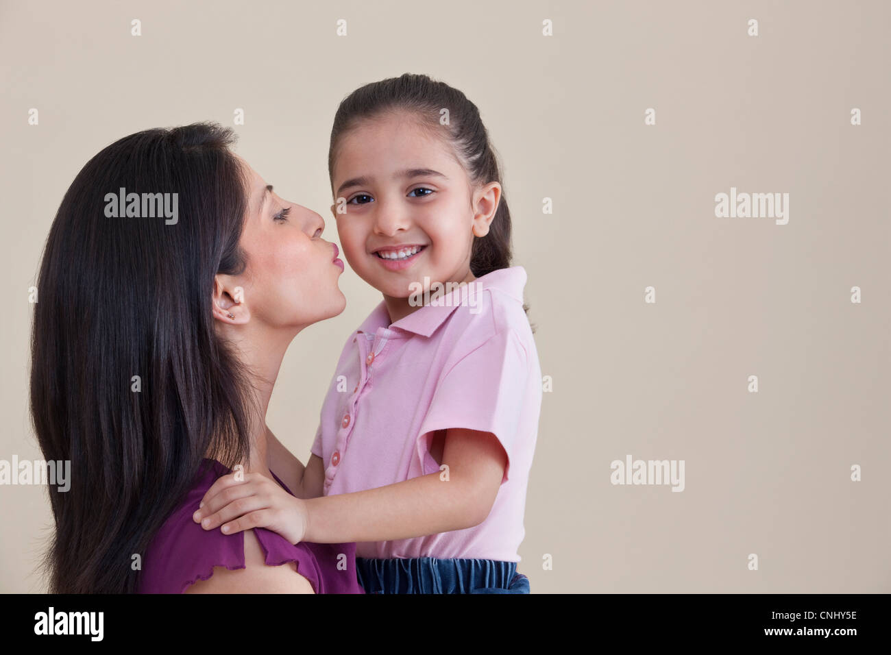 Mother kissing her daughter Stock Photo