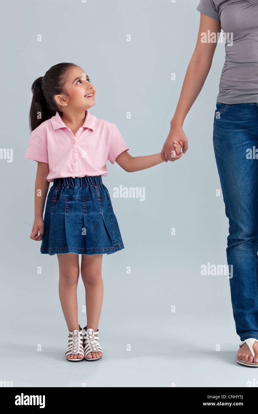 Young girl holding her mothers hand Stock Photo