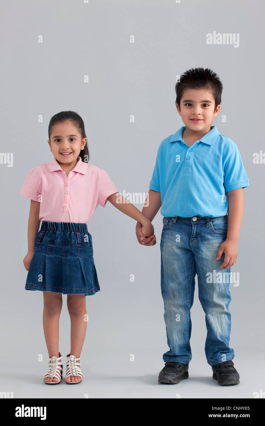 Brother and sister holding hands Stock Photo