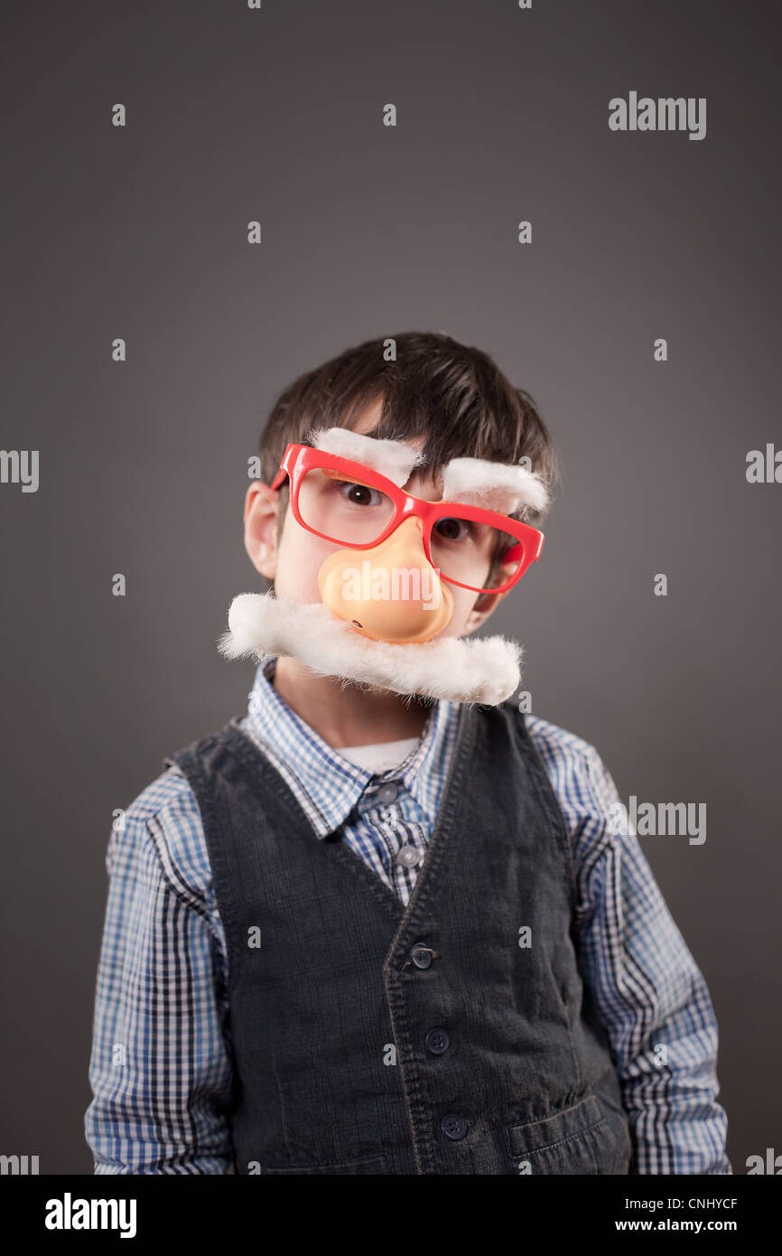 Boy wearing a funny face disguise Stock Photo
