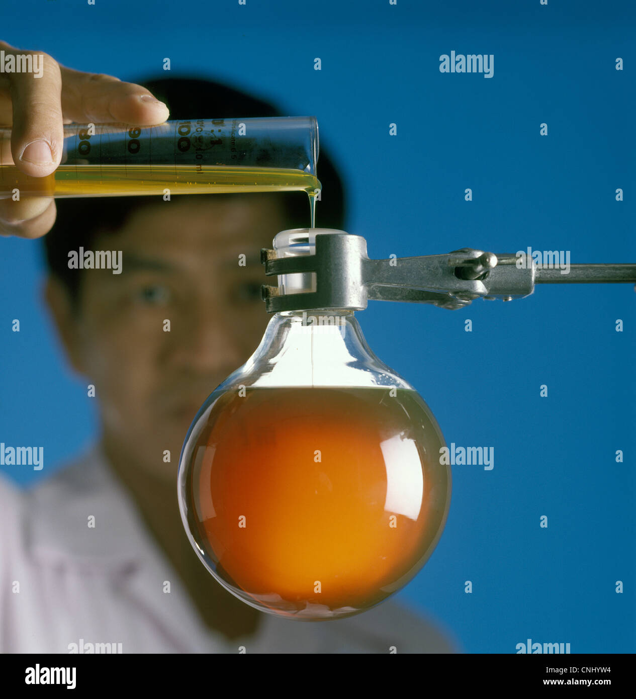 Lab assistant pouring chemicals Stock Photo Alamy