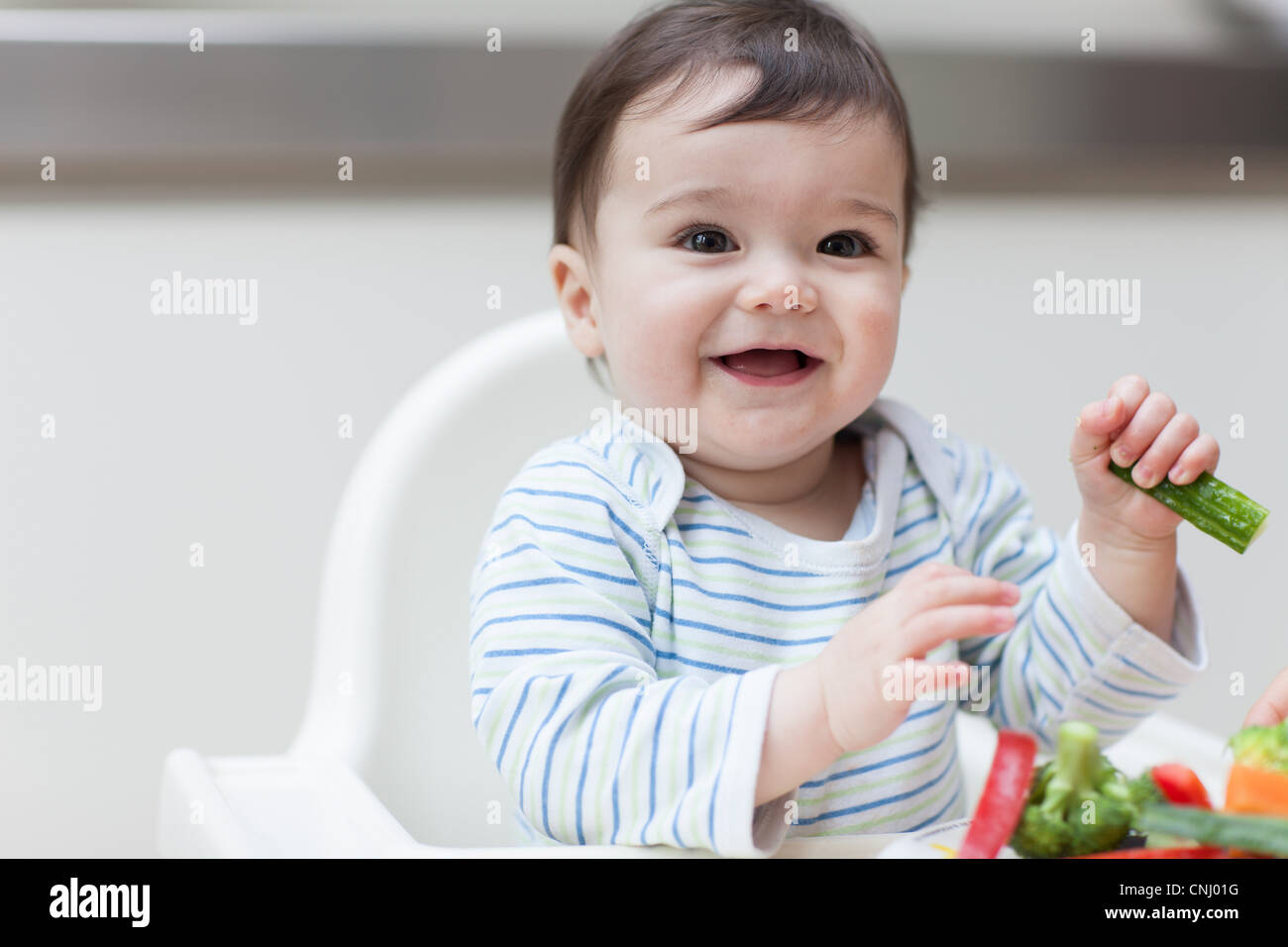 Baby boy eating healthy vegetables Stock Photo Alamy