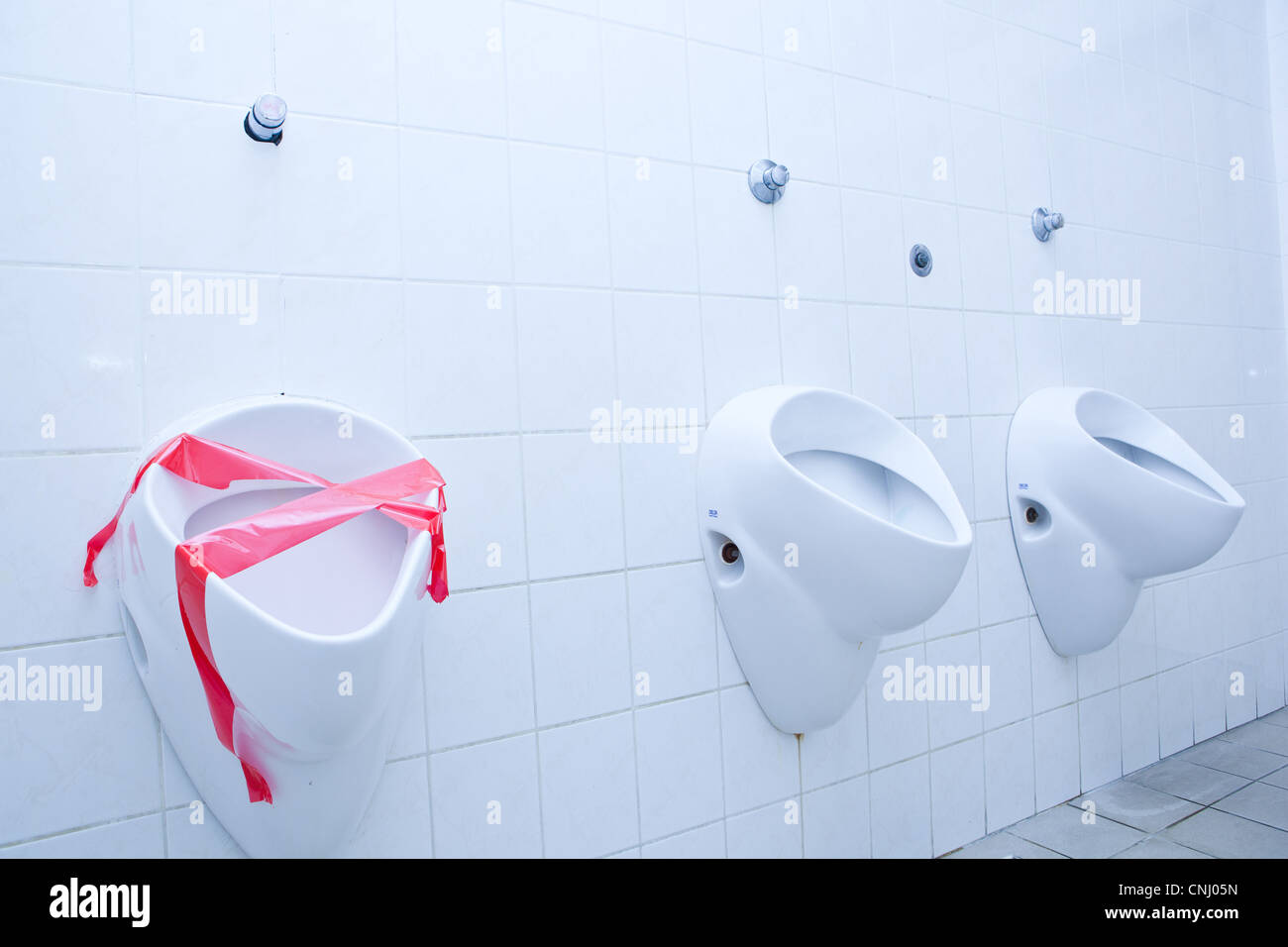 out of order concept - man restroom with three urinals/pissoirs out of