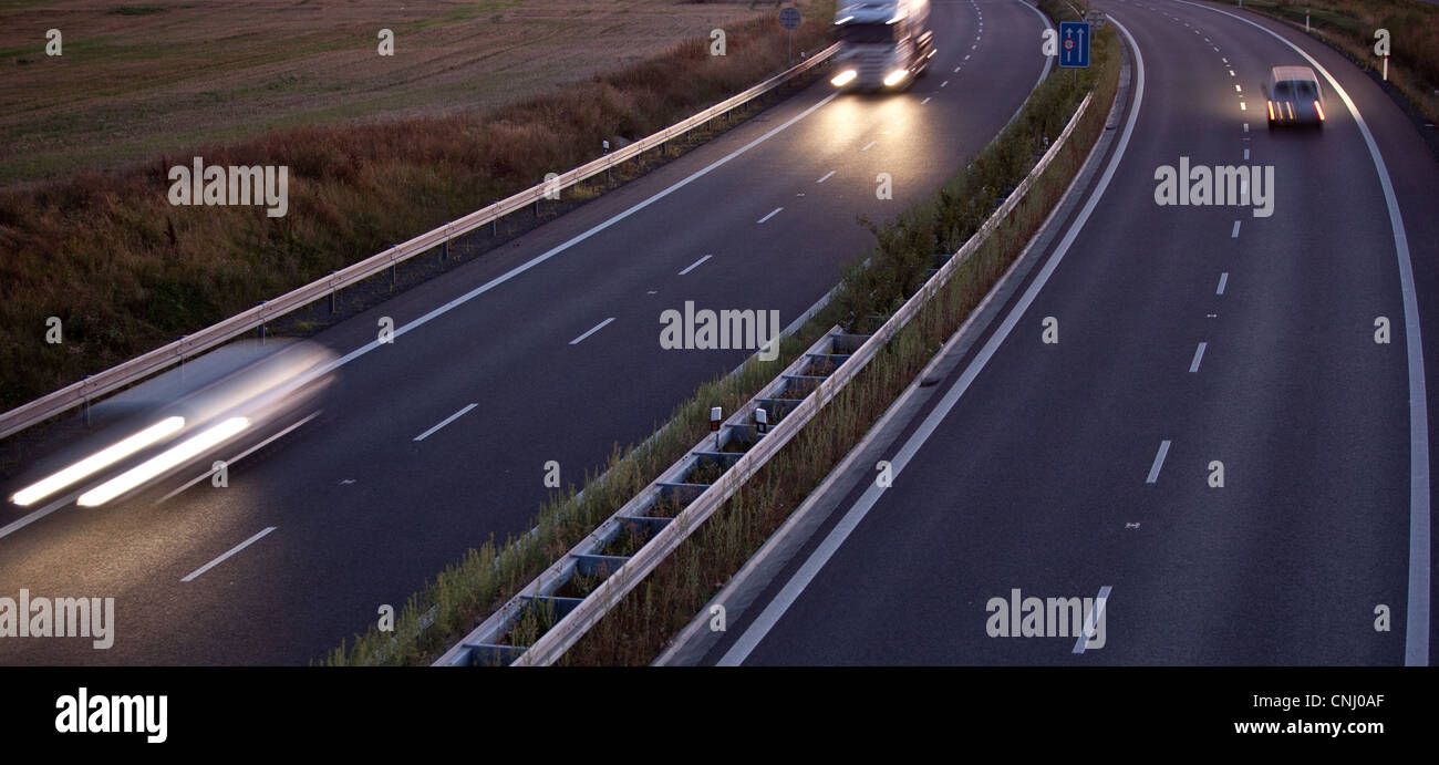 highway traffic - motion blurred truck on a highway/motorway/speedway ...