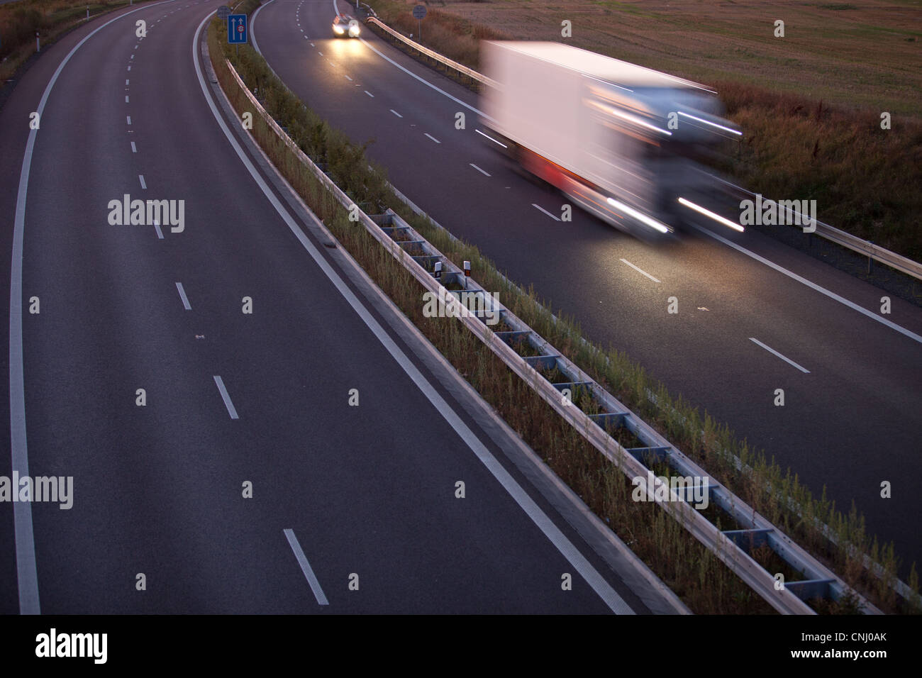 highway traffic - motion blurred truck on a highway/motorway/speedway ...