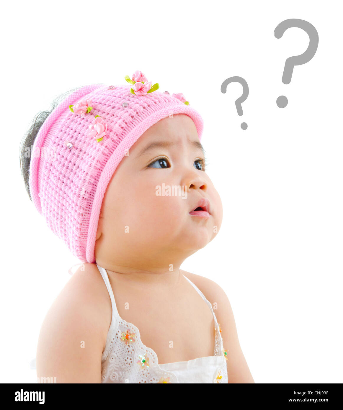 Wondering pan Asian baby girl with question mark isolated on white background Stock Photo