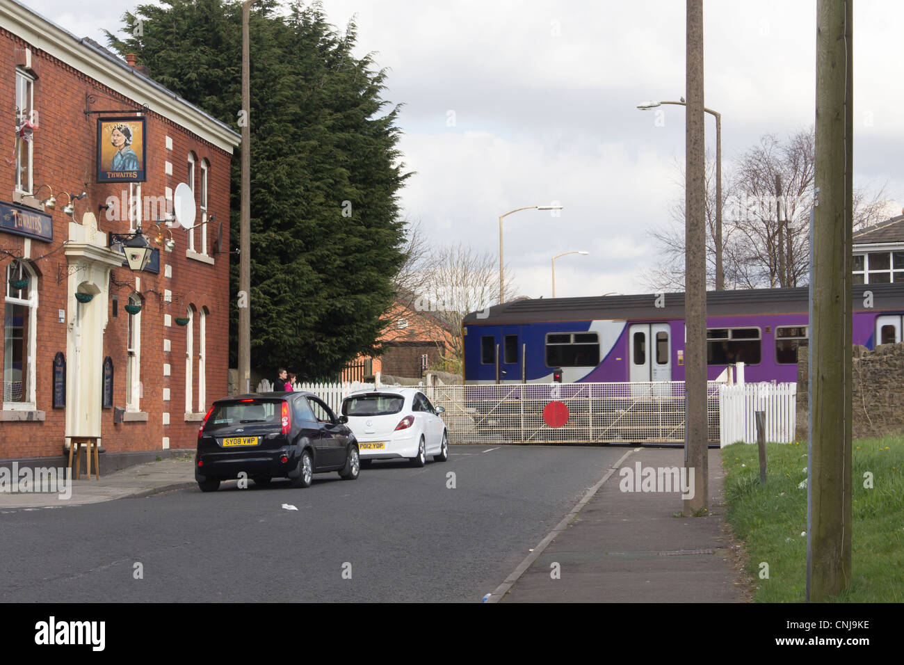 Traffic waiting for the passing train at the manually operated railway