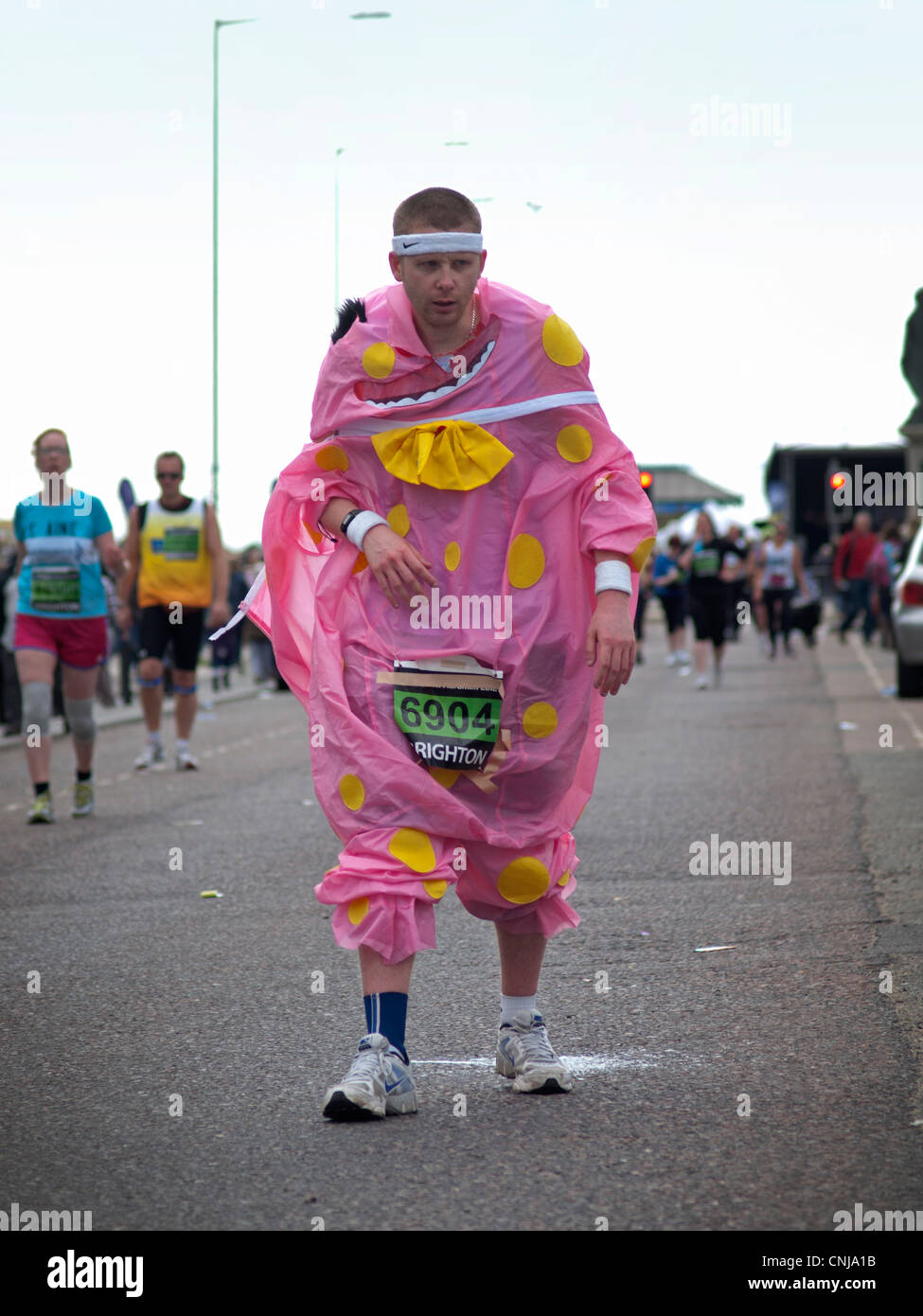 A runner in a Mr Blobby costume staggers in the Brighton Marathon Stock