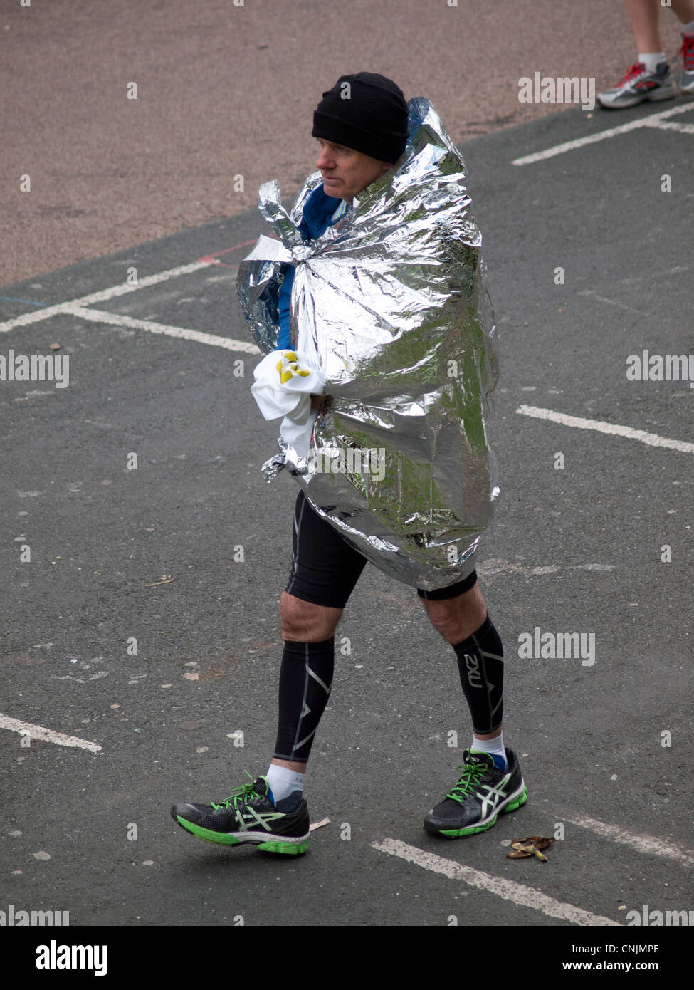 A runner wrapped in a foil blanket Stock Photo Alamy