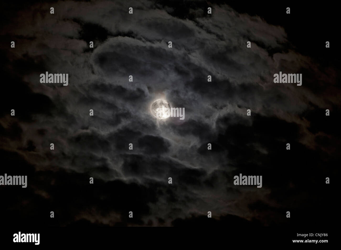 Full moon behind clouds Stock Photo Alamy