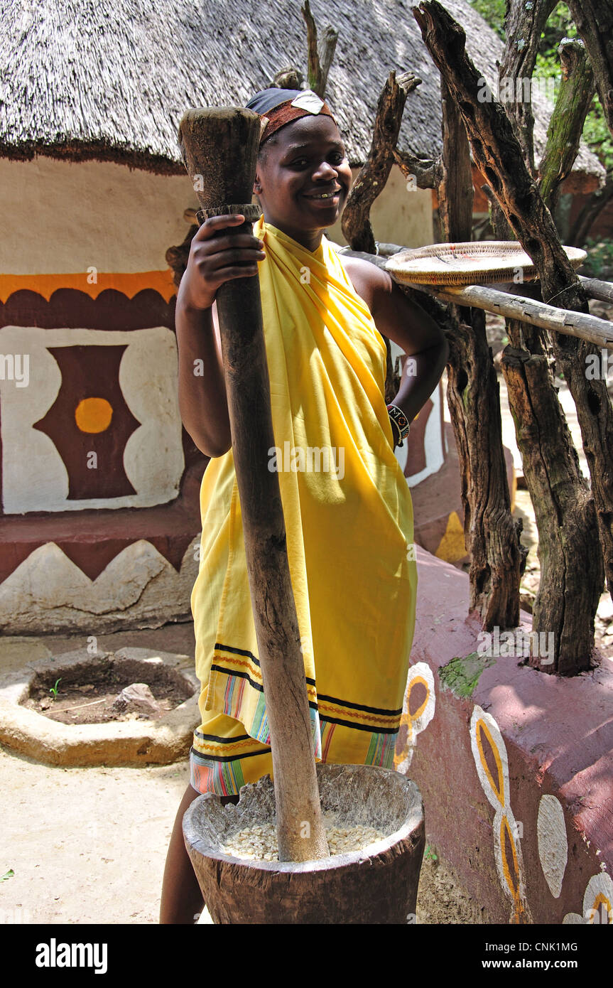 Girl grinding corn in Pedi village, Lesedi African Cultural Village, Broederstroom, Johannesburg, Gauteng, South Africa Stock Photo