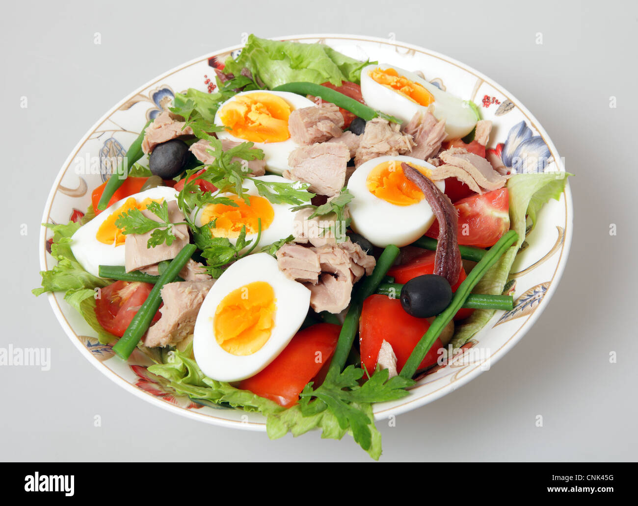 A serving bowl of freshly made traditional nicoise salad lettuce