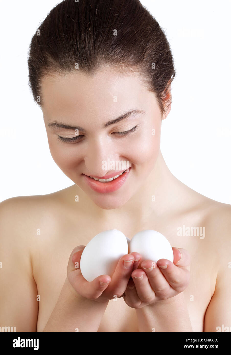 Beautiful young woman holding white eggs Stock Photo