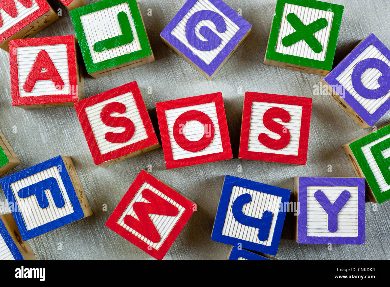 Wooden blocks forming the letters SOS in the center Stock Photo