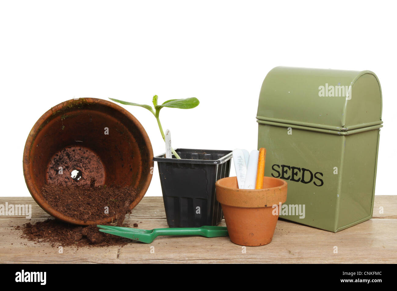 Garden potting bench, pots tools compost and a plant seedling on a