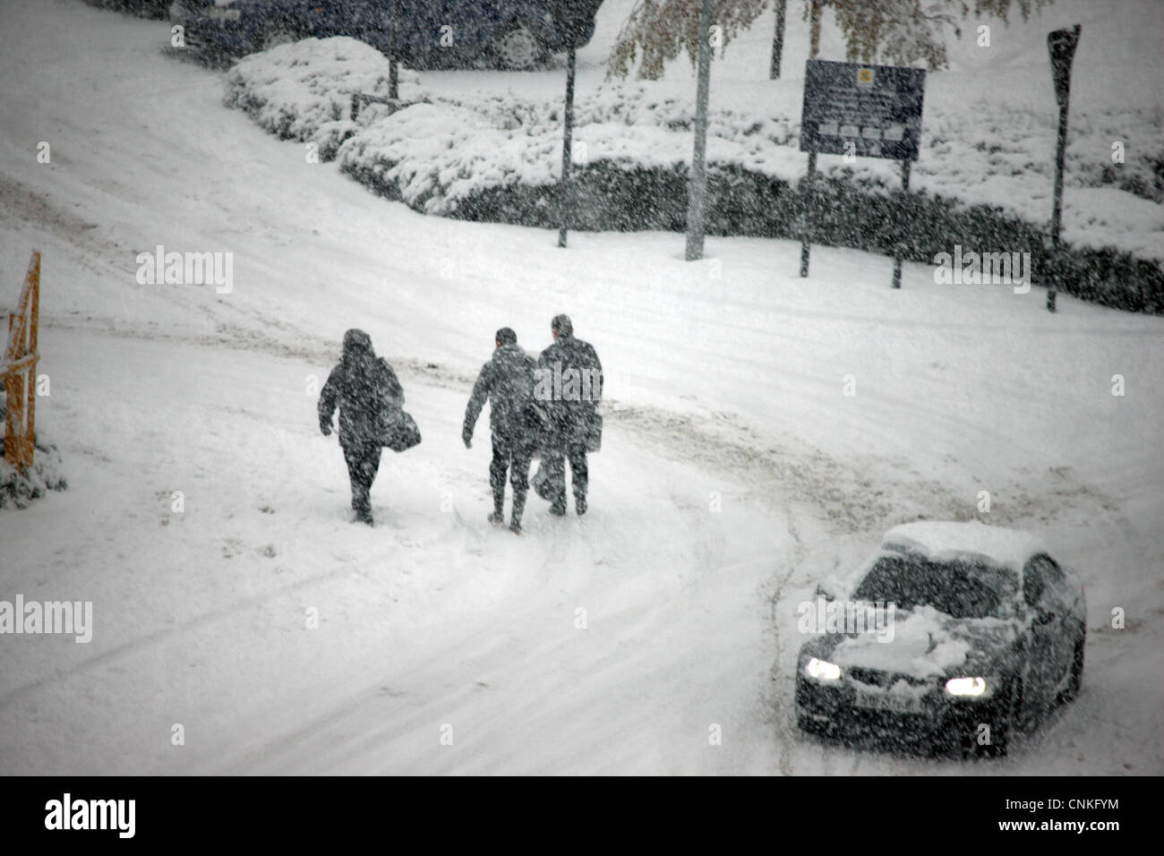 People and cars on treacherous snowy road in Scotland during the winter Stock Photo