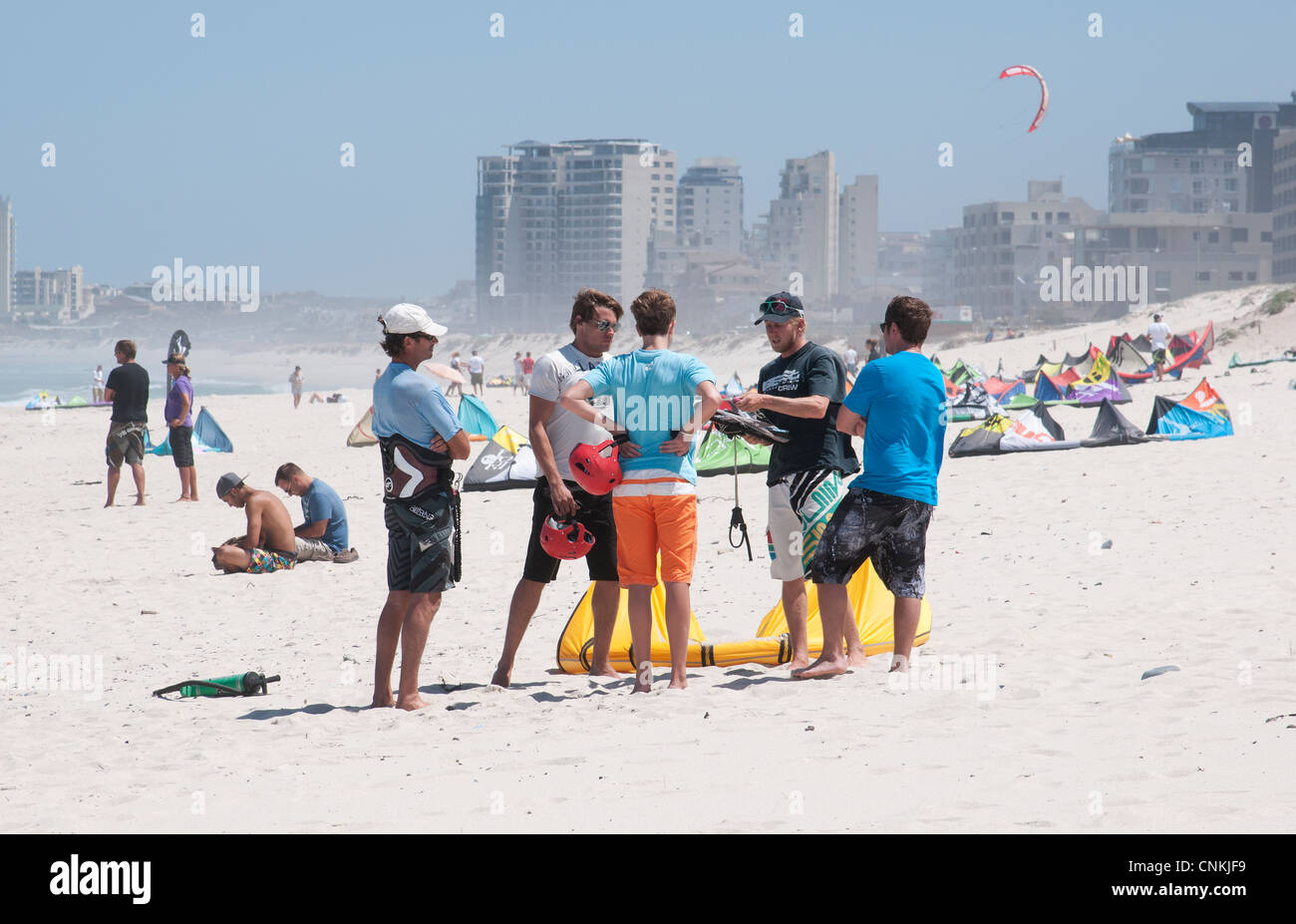 Young men get tuition in kite boarding on the Sunset Beach near Cape Town South Africa Stock Photo