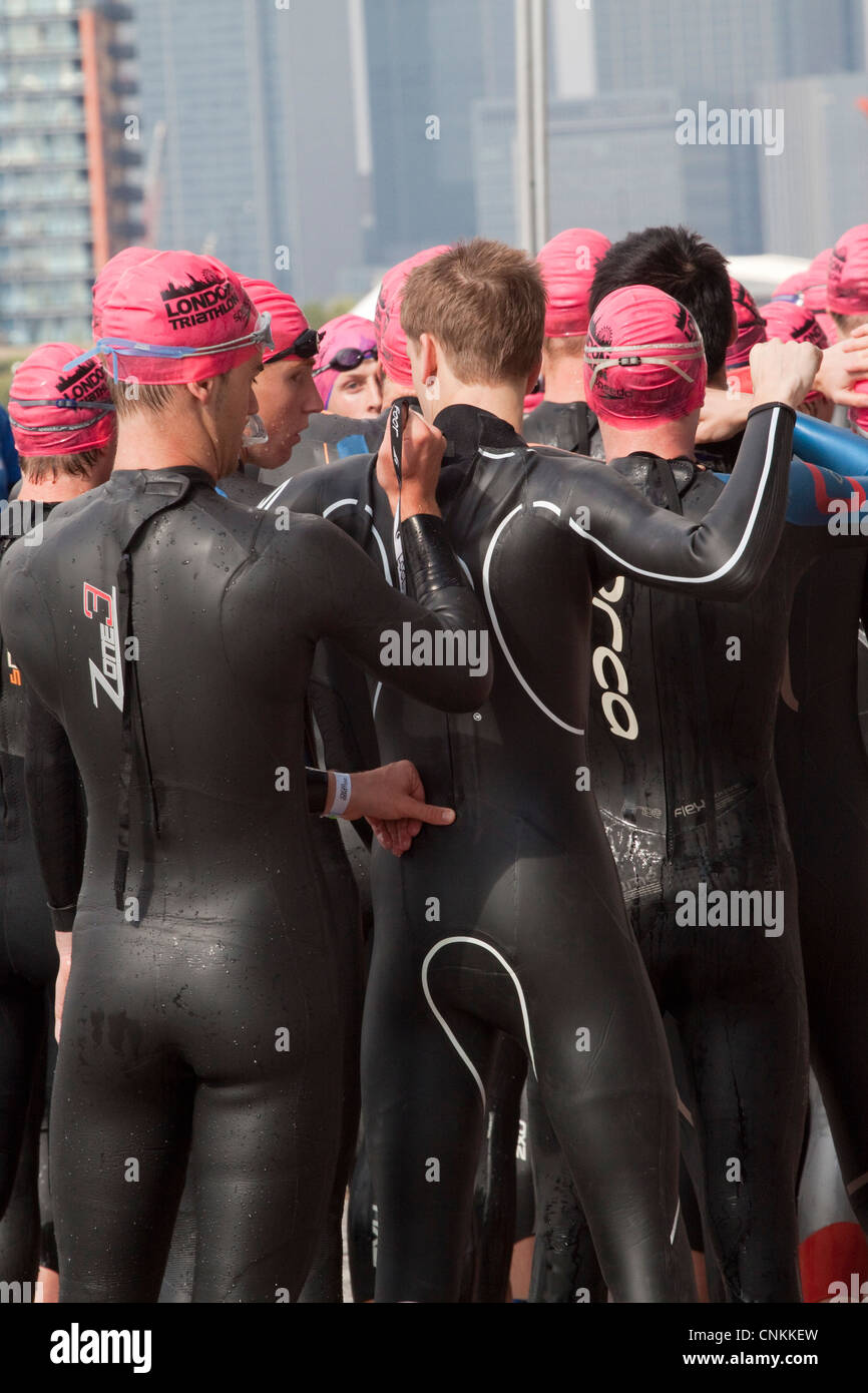 Male swimmers in wetsuits waiting for the start of a London triathlon at the ExCel Centre Stock