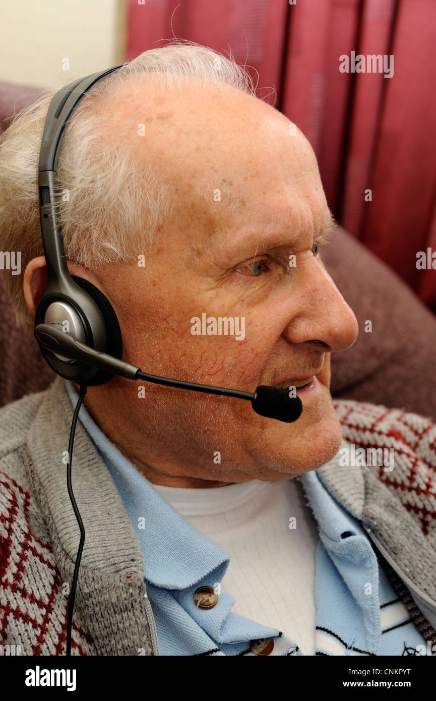male pensioner with headphones and attached microphone england uk Stock Photo